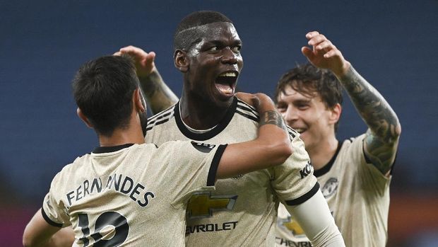 Manchester United's Paul Pogba, centre, celebrates with teammates after scoring his team's third goal during the English Premier League soccer match between Aston Villa and Manchester United at Villa Park in Birmingham, England, Thursday, July 9, 2020. (AP Photo/Shaun Botterill,Pool)