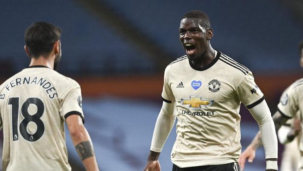 Manchester United's Paul Pogba, right, celebrates after scoring his team's third goal during the English Premier League soccer match between Aston Villa and Manchester United at Villa Park in Birmingham, England, Thursday, July 9, 2020. (AP Photo/Shaun Botterill,Pool)