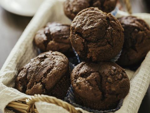 Chocolate muffins on wooden board. Sweet food. Tasty chocolate cakes