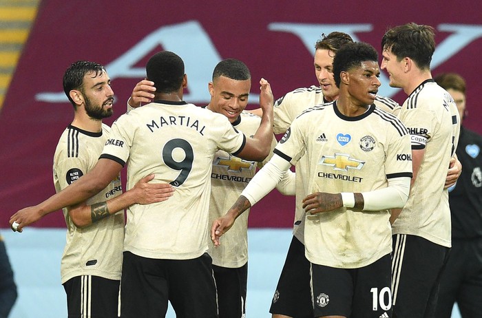 BIRMINGHAM, ENGLAND - JULY 09: Mason Greenwood of Manchester United celebrates with his team mates after scoring his teams second goal during the Premier League match between Aston Villa and Manchester United at Villa Park on July 09, 2020 in Birmingham, England. Football Stadiums around Europe remain empty due to the Coronavirus Pandemic as Government social distancing laws prohibit fans inside venues resulting in all fixtures being played behind closed doors. (Photo by Oli Scarff/Pool via Getty Images)