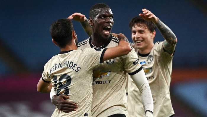 BIRMINGHAM, ENGLAND - JULY 09: Paul Pogba of Manchester United celebrates with Bruno Fernandes and Victor Lindelof after scoring his teams third goal during the Premier League match between Aston Villa and Manchester United at Villa Park on July 09, 2020 in Birmingham, England. Football Stadiums around Europe remain empty due to the Coronavirus Pandemic as Government social distancing laws prohibit fans inside venues resulting in all fixtures being played behind closed doors. (Photo by Shaun Botterill/Getty Images)