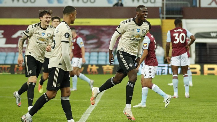 Manchester Uniteds Paul Pogba celebrates after scoring his teams third goal during the English Premier League soccer match between Aston Villa and Manchester United at Villa Park in Birmingham, England, Thursday, July 9, 2020. (AP PhotoAndrew Boyers,Pool)