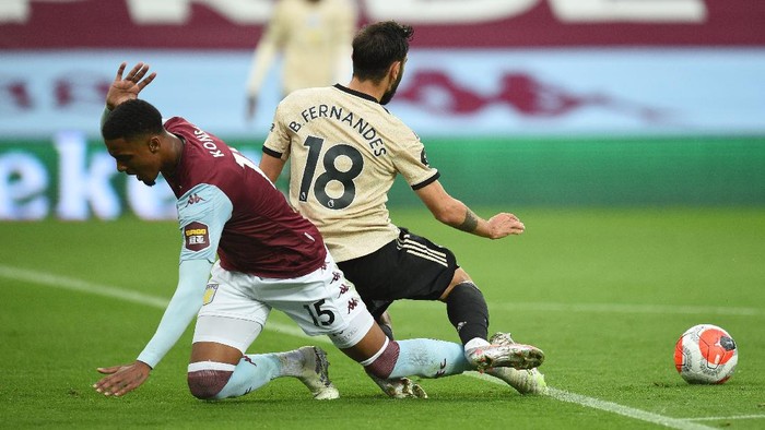 BIRMINGHAM, ENGLAND - JULY 09: Bruno Fernandes of Manchester United is fouled by Ezri Konsa Ngoyo of Aston Villa and a penalty is awarded during the Premier League match between Aston Villa and Manchester United at Villa Park on July 09, 2020 in Birmingham, England. Football Stadiums around Europe remain empty due to the Coronavirus Pandemic as Government social distancing laws prohibit fans inside venues resulting in all fixtures being played behind closed doors. (Photo by Oli Scarff/Pool via Getty Images)