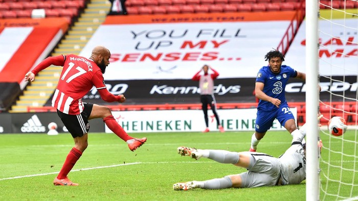 SHEFFIELD, ENGLAND - JULY 11: David McGoldrick of Sheffield United scores his teams first goal past Kepa Arrizabalaga of Chelsea during the Premier League match between Sheffield United and Chelsea FC at Bramall Lane on July 11, 2020 in Sheffield, England. Football Stadiums around Europe remain empty due to the Coronavirus Pandemic as Government social distancing laws prohibit fans inside venues resulting in all fixtures being played behind closed doors. (Photo by Peter Powell/Pool via Getty Images)