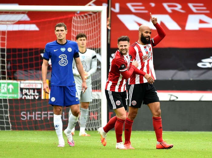 SHEFFIELD, ENGLAND - JULY 11: David McGoldrick of Sheffield United celebrates with teammate Ollie Norwood after scoring his teams first goal during the Premier League match between Sheffield United and Chelsea FC at Bramall Lane on July 11, 2020 in Sheffield, England. Football Stadiums around Europe remain empty due to the Coronavirus Pandemic as Government social distancing laws prohibit fans inside venues resulting in all fixtures being played behind closed doors. (Photo by Rui Vieira/Pool via Getty Images)