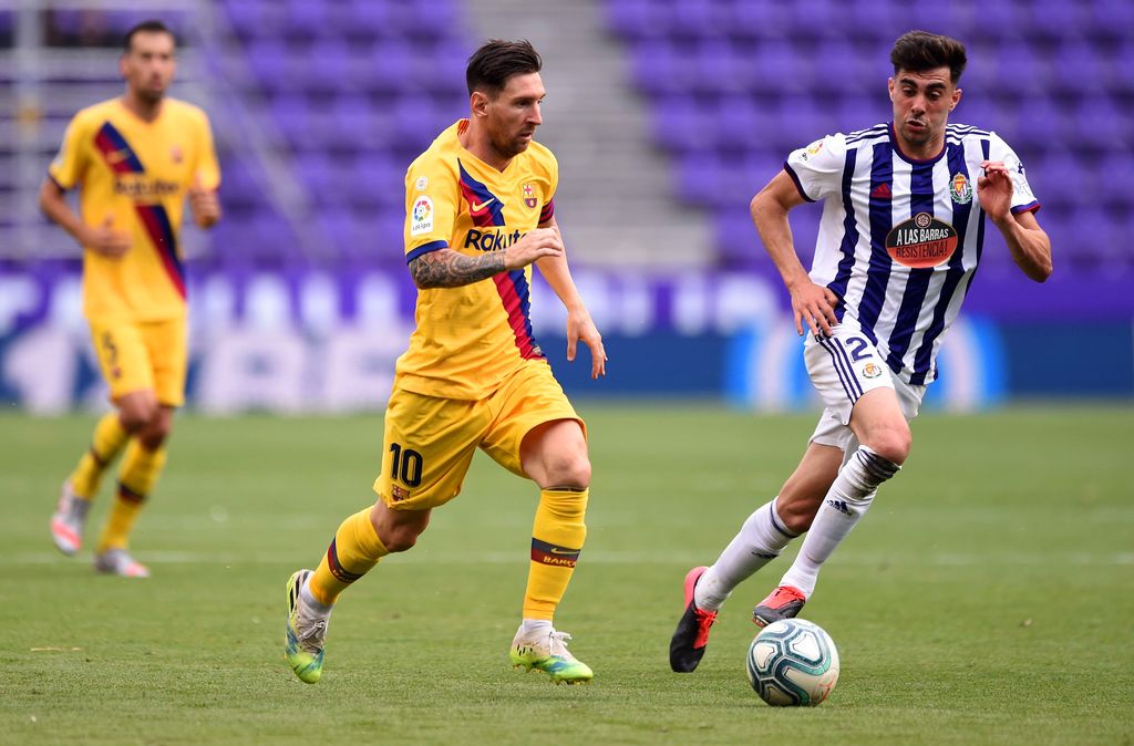 VALLADOLID, SPAIN - JULY 11: Lionel Messi of Barcelona and Kike Perez of Real Valladolid battle for the ball during the Liga match between Real Valladolid CF and FC Barcelona at Jose Zorrilla on July 11, 2020 in Valladolid, Spain. Football Stadiums around Europe remain empty due to the Coronavirus Pandemic as Government social distancing laws prohibit fans inside venues resulting in all fixtures being played behind closed doors. (Photo by Denis Doyle/Getty Images)