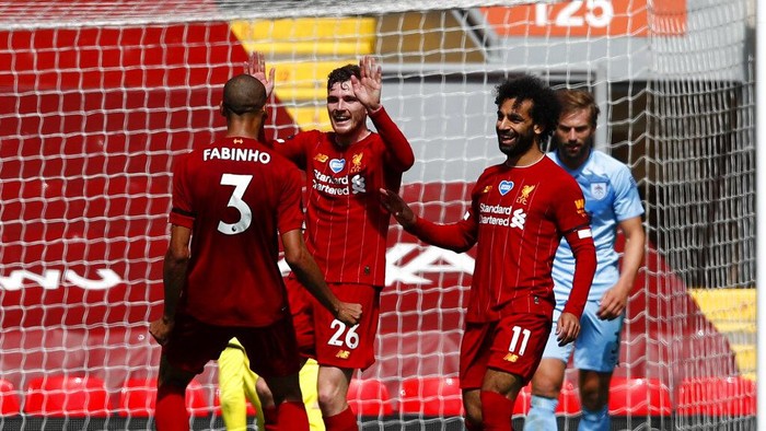 Liverpools Andrew Robertson, second left, celebrates with teammates after scoring the opening goal of the game during the English Premier League soccer match between Liverpool and Burnley at Anfield, Liverpool, England, Saturday, July 11, 2020. (Clive Brunskill/ Pool via AP)