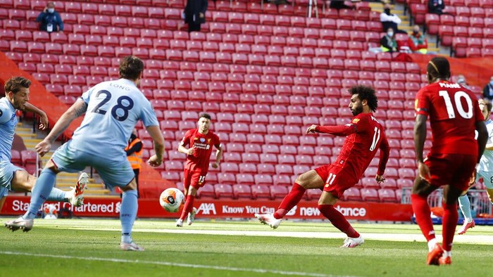 Liverpools Mohamed Salah shots, second right, at goal during the English Premier League soccer match between Liverpool and Burnley at Anfield in Liverpool, England, Saturday , July 11, 2020. (Phil Noble/Pool via AP)