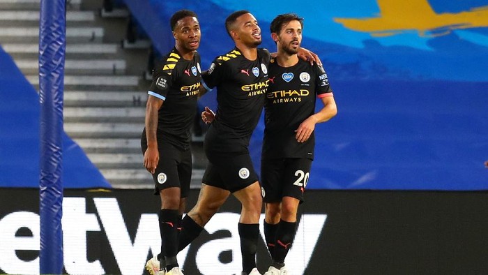 BRIGHTON, ENGLAND - JULY 11: Bernardo Silva of Manchester City celebrates with teammates Gabriel Jesus and Raheem Sterling after scoring his teams fourth goal during the Premier League match between Brighton & Hove Albion and Manchester City at American Express Community Stadium on July 11, 2020 in Brighton, England. Football Stadiums around Europe remain empty due to the Coronavirus Pandemic as Government social distancing laws prohibit fans inside venues resulting in all fixtures being played behind closed doors. (Photo by Catherine Ivill/Getty Images)