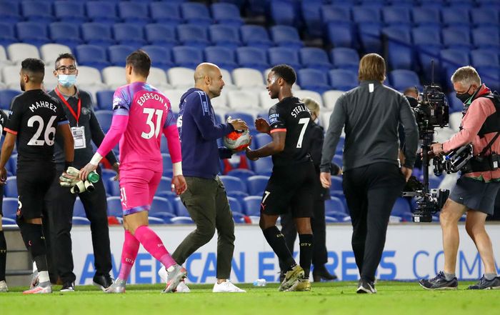 Pep Guardiola BRIGHTON, ENGLAND - JULY 11: Pep Guardiola, Manager of Manchester City interacts with Raheem Sterling of Manchester City as they celebrate victory following the Premier League match between Brighton & Hove Albion and Manchester City at American Express Community Stadium on July 11, 2020 in Brighton, England. Football Stadiums around Europe remain empty due to the Coronavirus Pandemic as Government social distancing laws prohibit fans inside venues resulting in all fixtures being played behind closed doors. (Photo by Julian Finney/Getty Images)