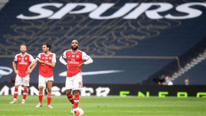 Arsenal LONDON, ENGLAND - JULY 12: Alexandre Lacazette of Arsenal reacts after Tottenham Hotspur score their second goal during the Premier League match between Tottenham Hotspur and Arsenal FC at Tottenham Hotspur Stadium on July 12, 2020 in London, England. Football Stadiums around Europe remain empty due to the Coronavirus Pandemic as Government social distancing laws prohibit fans inside venues resulting in all fixtures being played behind closed doors. (Photo by Michael Regan/Getty Images)