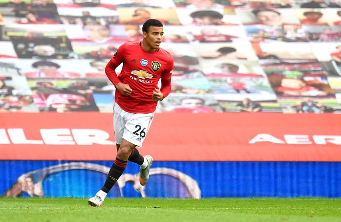 MANCHESTER, ENGLAND - JULY 04: Mason Greenwood of Manchester United celebrates after scoring his teams first goal during the Premier League match between Manchester United and AFC Bournemouth  at Old Trafford on July 04, 2020 in Manchester, England. Football Stadiums around Europe remain empty due to the Coronavirus Pandemic as Government social distancing laws prohibit fans inside venues resulting in all fixtures being played behind closed doors. (Photo by Peter Powell/Pool via Getty Images)