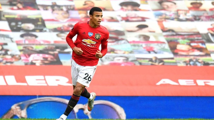 MANCHESTER, ENGLAND - JULY 04: Mason Greenwood of Manchester United celebrates after scoring his teams first goal during the Premier League match between Manchester United and AFC Bournemouth  at Old Trafford on July 04, 2020 in Manchester, England. Football Stadiums around Europe remain empty due to the Coronavirus Pandemic as Government social distancing laws prohibit fans inside venues resulting in all fixtures being played behind closed doors. (Photo by Peter Powell/Pool via Getty Images)