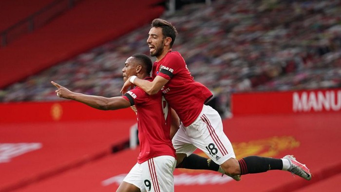 MANCHESTER, ENGLAND - JULY 13: Anthony Martial of Manchester United celebrates with teammates Bruno Fernandes and Marcus Rashford of Manchester United after scoring his teams second goal during the Premier League match between Manchester United and Southampton FC at Old Trafford on July 13, 2020 in Manchester, England. Football Stadiums around Europe remain empty due to the Coronavirus Pandemic as Government social distancing laws prohibit fans inside venues resulting in all fixtures being played behind closed doors. (Photo by Dave Thompson/Pool via Getty Images)