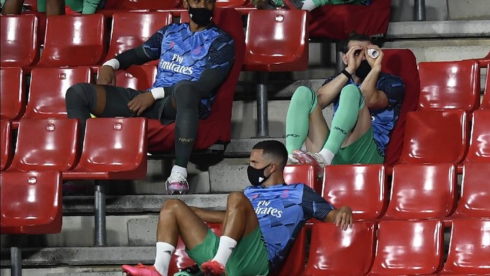 Real Madrids Gareth Bale, right, gestures from the stands ahead of the Spanish La Liga soccer match between Granada and Real Madrid at the Los Carmenes stadium in Granada, Spain, Monday, July 13, 2020. (AP Photo/Jose Breton)