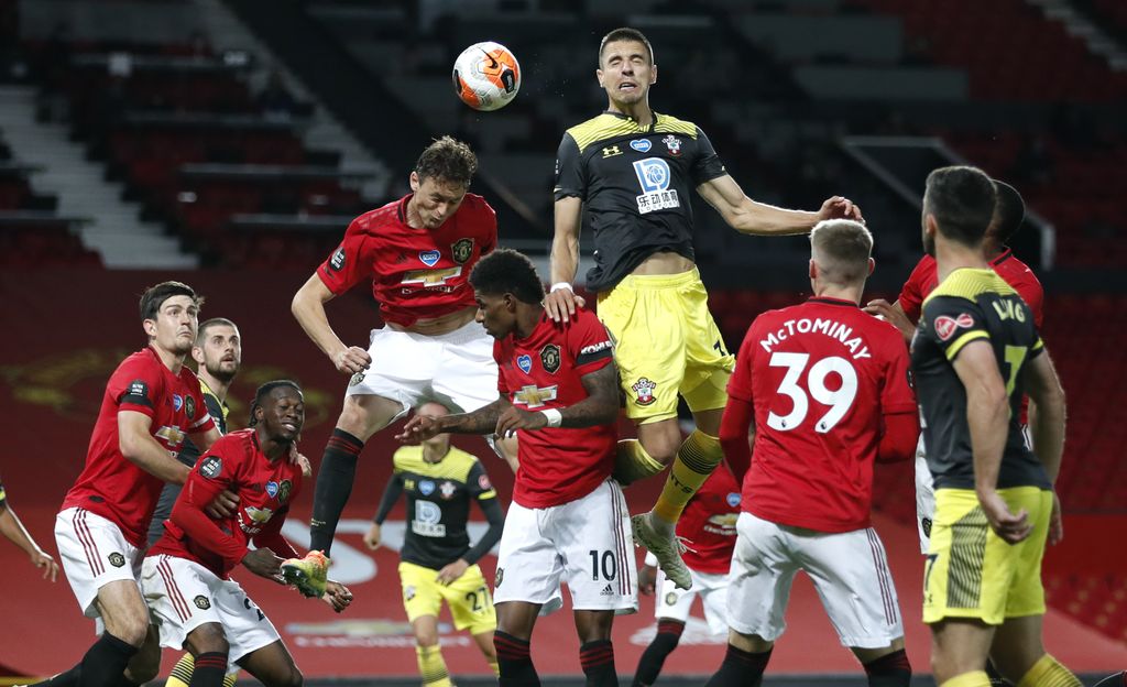 Southampton's Jan Bednarek heads the ball during the English Premier League soccer match between Manchester United and Southampton at Old Trafford in Manchester, England, Monday, July 13, 2020. (AP Photo/Clive Brunskill,Pool)