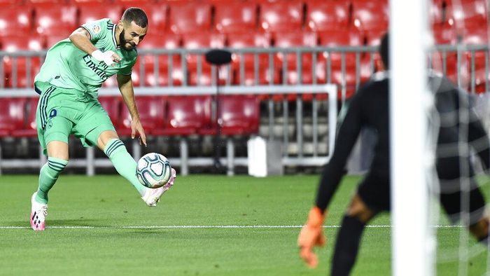 Karim Benzema Real Madrids Karim Benzema kicks the ball during the Spanish La Liga soccer match between Granada and Real Madrid at the Los Carmenes stadium in Granada, Spain, Monday, July 13, 2020. (AP Photo/Jose Breton)