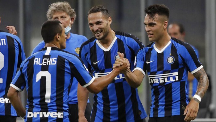 Inter Milans Lautaro Martinez, right, celebrates after scoring his sides third goal during a Serie A soccer match between Inter Milan and Torino, at the San Siro stadium in Milan, Italy, Monday, July 13, 2020. (AP Photo/Luca Bruno