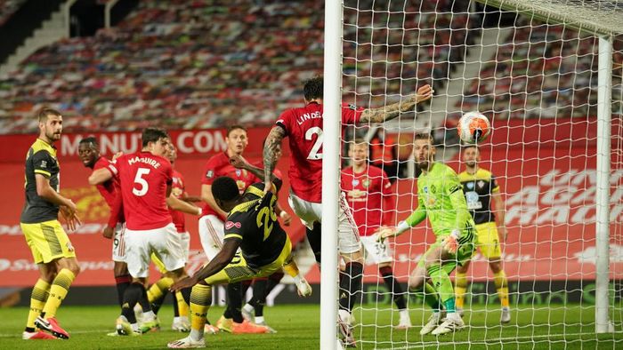 Manchester United, Southampton MANCHESTER, ENGLAND - JULY 13: Michael Obafemi of Southampton scores his teams second goal past Victor Lindelof of Manchester United during the Premier League match between Manchester United and Southampton FC at Old Trafford on July 13, 2020 in Manchester, England. Football Stadiums around Europe remain empty due to the Coronavirus Pandemic as Government social distancing laws prohibit fans inside venues resulting in all fixtures being played behind closed doors. (Photo by Dave Thompson/Pool via Getty Images)