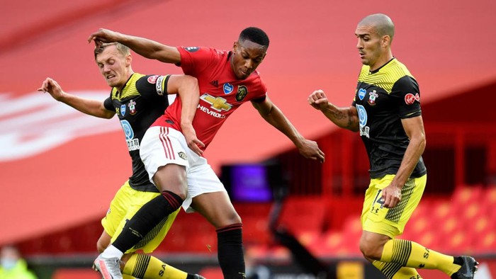 MANCHESTER, ENGLAND - JULY 13: Anthony Martial of Manchester United battles for possession with James Ward-Prowse and Oriol Romeu of Southampton during the Premier League match between Manchester United and Southampton FC at Old Trafford on July 13, 2020 in Manchester, England. Football Stadiums around Europe remain empty due to the Coronavirus Pandemic as Government social distancing laws prohibit fans inside venues resulting in all fixtures being played behind closed doors. (Photo by Peter Powell/Pool via Getty Images)