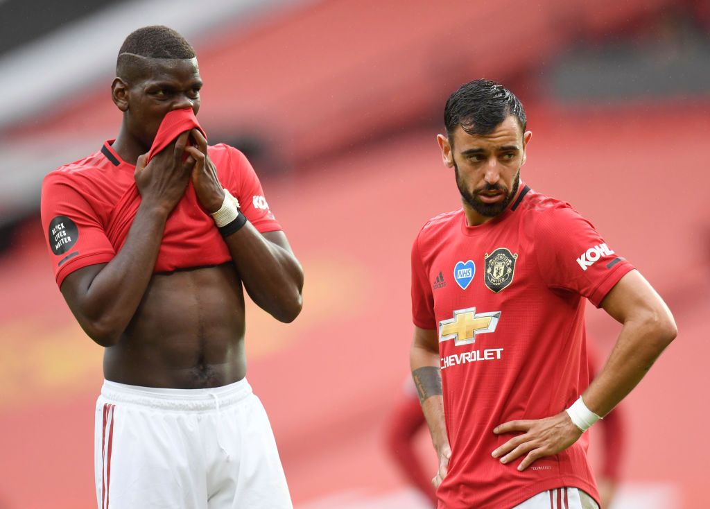 MANCHESTER, ENGLAND - JULY 04: Paul Pogba and Bruno Fernandes of Manchester United speak during the Premier League match between Manchester United and AFC Bournemouth  at Old Trafford on July 04, 2020 in Manchester, England. Football Stadiums around Europe remain empty due to the Coronavirus Pandemic as Government social distancing laws prohibit fans inside venues resulting in all fixtures being played behind closed doors. (Photo by Peter Powell/Pool via Getty Images)
