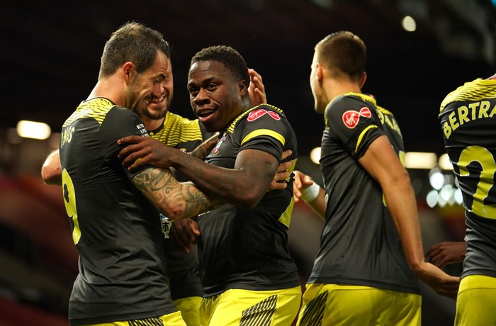 MANCHESTER, ENGLAND - JULY 13: Michael Obafemi of Southampton celebrates with teammates after scoring his teams second goal during the Premier League match between Manchester United and Southampton FC at Old Trafford on July 13, 2020 in Manchester, England. Football Stadiums around Europe remain empty due to the Coronavirus Pandemic as Government social distancing laws prohibit fans inside venues resulting in all fixtures being played behind closed doors. (Photo by Dave Thompson/Pool via Getty Images)