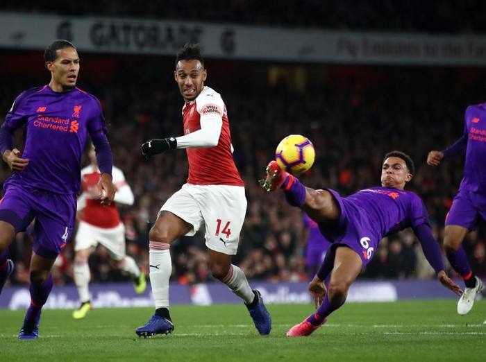 LONDON, ENGLAND - NOVEMBER 03:  Trent Alexander-Arnold of Liverpool (on the ground) controls the ball as Virgil van Dijk of Liverpool, Pierre-Emerick Aubameyang of Arsenal and Joe Gomez of Liverpool look on during the Premier League match between Arsenal FC and Liverpool FC at Emirates Stadium on November 3, 2018 in London, United Kingdom.  (Photo by Julian Finney/Getty Images)