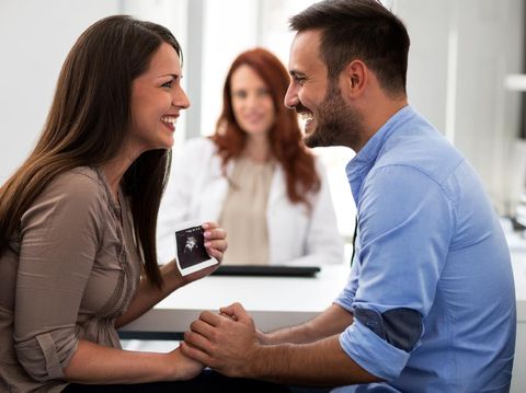 Doctor during consultation held in his hand and shows patient anatomical model of male sperm. Counseling of men and couples about male infertility, sperm pathology, impossibility to get pregnant