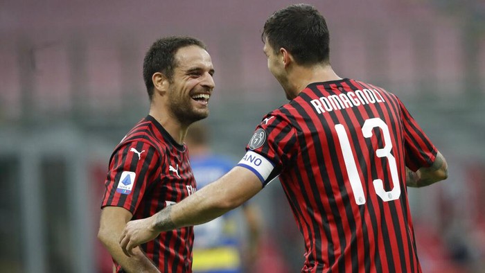 AC Milans Alessio Romagnoli, right, celebrates his goal with his teammate Giacomo Bonaventura, left, during a Serie A soccer match between AC Milan and Parma, at the San Siro stadium in Milan, Italy, Wednesday, July 15, 2020. (AP Photo/Luca Bruno)