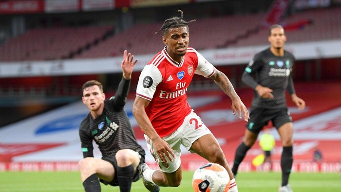LONDON, ENGLAND - JULY 15: Reiss Nelson of Arsenal runs with the ball during the Premier League match between Arsenal FC and Liverpool FC at Emirates Stadium on July 15, 2020 in London, England. Football Stadiums around Europe remain empty due to the Coronavirus Pandemic as Government social distancing laws prohibit fans inside venues resulting in all fixtures being played behind closed doors. (Photo by Shaun Botterill/Getty Images)
