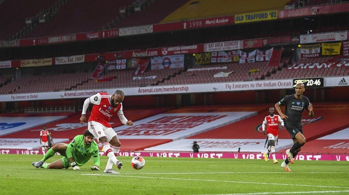 Arsenals Alexandre Lacazette scores his team first goal during the English Premier League soccer match between Arsenal and Liverpool at the Emirates Stadium in London, England, Wednesday, July 15, 2020. (Shaun Botterill/Pool via AP)