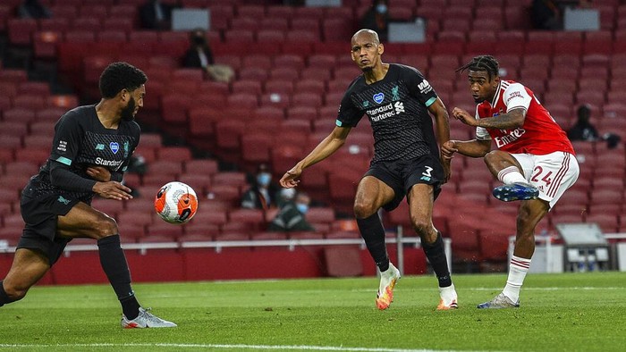 Arsenals Reiss Nelson, right, scores his team second goal during the English Premier League soccer match between Arsenal and Liverpool at the Emirates Stadium in London, England, Wednesday, July 15, 2020. (Glyn Kirk/Pool via AP)