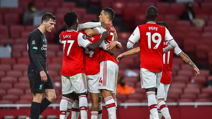 Britain Soccer Premier League, Arsenal Vs Liverpool Arsenal players celebrate after scoring their second goal during the English Premier League soccer match between Arsenal and Liverpool at the Emirates Stadium in London, England, Wednesday, July 15, 2020. Glyn Kirk/Pool via AP)