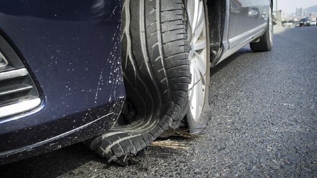 damaged tire after tire explosion at high speed on highway