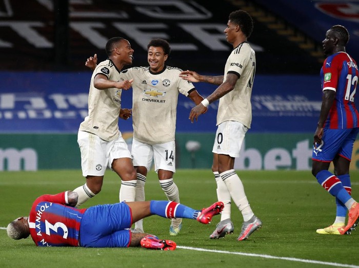 LONDON, ENGLAND - JULY 16: Anthony Martial of Manchester United celebrates after scoring his sides first goal as Patrick van Aanholt of Crystal Palace reacts during the Premier League match between Crystal Palace and Manchester United at Selhurst Park on July 16, 2020 in London, England. Football Stadiums around Europe remain empty due to the Coronavirus Pandemic as Government social distancing laws prohibit fans inside venues resulting in all fixtures being played behind closed doors. (Photo by Peter Cziborra/Pool via Getty Images)