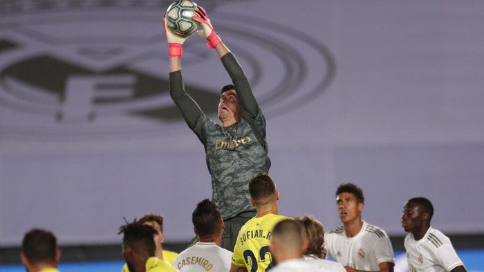 Real Madrids goalkeeper Thibaut Courtois blocks the ball during the Spanish La Liga soccer match between Real Madrid and Villareal at the Alfredo di Stefano stadium in Madrid, Spain, Thursday, July 16, 2020. (AP Photo/Bernat Armangue)