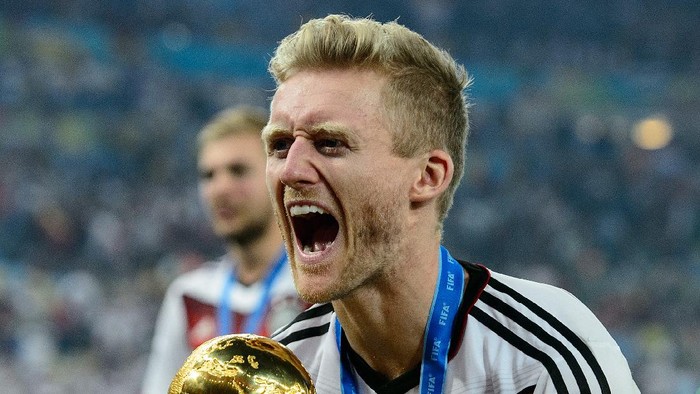 RIO DE JANEIRO, BRAZIL - JULY 13:  Andre Schuerrle celebrates with the World Cup trophy after defeating Argentina 1-0 in extra time during the 2014 FIFA World Cup Brazil Final match between Germany and Argentina at Maracana on July 13, 2014 in Rio de Janeiro, Brazil.  (Photo by Matthias Hangst/Getty Images)