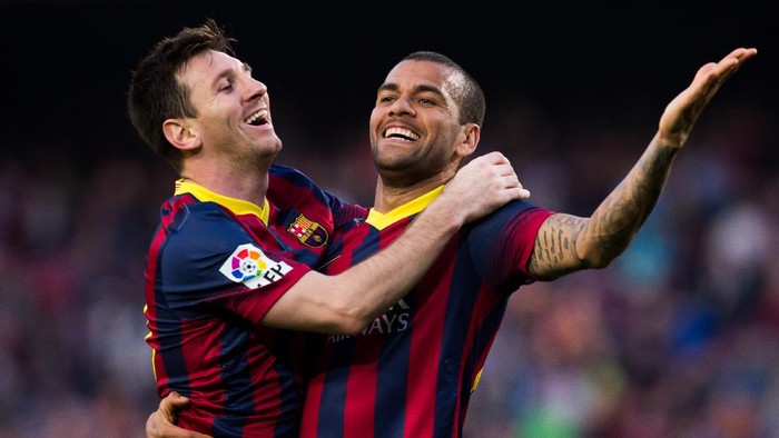 BARCELONA, SPAIN - MARCH 16: Lionel Messi of FC Barcelona celebrates with his teammate Daniel Alves after scoring his teams sixth goal during the La Liga match between FC Barcelona and CA Osasuna at Camp Nou on March 16, 2014 in Barcelona, Spain. (Photo by Alex Caparros/Getty Images)