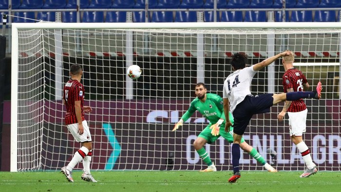 MILAN, ITALY - JULY 18:  Takehiro Tomiyasu #14 of Bologna FC scores his goal during the Serie A match between AC Milan and Bologna FC at Stadio Giuseppe Meazza on July 18, 2020 in Milan, Italy.  (Photo by Marco Luzzani/Getty Images)