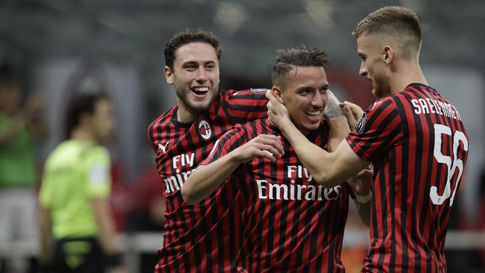 AC Milans Ismael Bennacer, centre, celebrates with team players after scoring during a Serie A soccer match between AC Milan and Bologna, at the San Siro stadium in Milan, Italy, Saturday, July 18, 2020. (AP Photo/Luca Bruno)