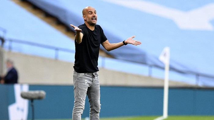 Manchester Citys head coach Pep Guardiola gestures during the FA Cup semifinal soccer match between Arsenal and Manchester City at Wembley in London, England, Saturday, July 18, 2020. (AP Photo/Justin Tallis,Pool)