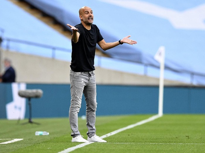 Manchester Citys head coach Pep Guardiola gestures during the FA Cup semifinal soccer match between Arsenal and Manchester City at Wembley in London, England, Saturday, July 18, 2020. (AP Photo/Justin Tallis,Pool)
