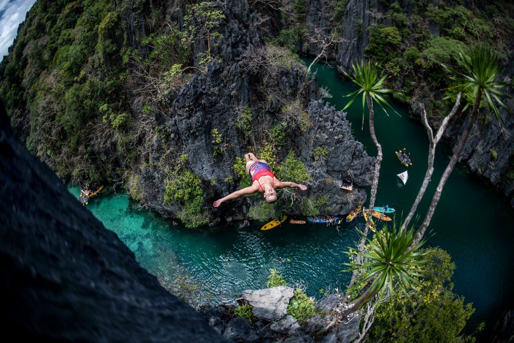 PALAWAN, PHILIPPINES - APRIL 12: (EDITORIAL USE ONLY) In this handout image provided by Red Bull, Blake Aldridge of the UK dives from a rock pinnacle at the Small Lagoon on Miniloc Island during the first competition day of the first stop of the Red Bull Cliff Diving World Series on April 12, 2019 at Palawan, Philippines. (Photo by Dean Treml/Red Bull via Getty Images)