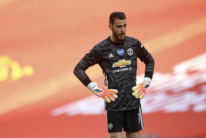 Manchester Uniteds goalkeeper David de Gea stands hands on hips after conceding the second goal during the English FA Cup semifinal soccer match between Chelsea and Manchester United at Wembley Stadium in London, England, Sunday, July 19, 2020. (Andy Rain, Pool via AP)