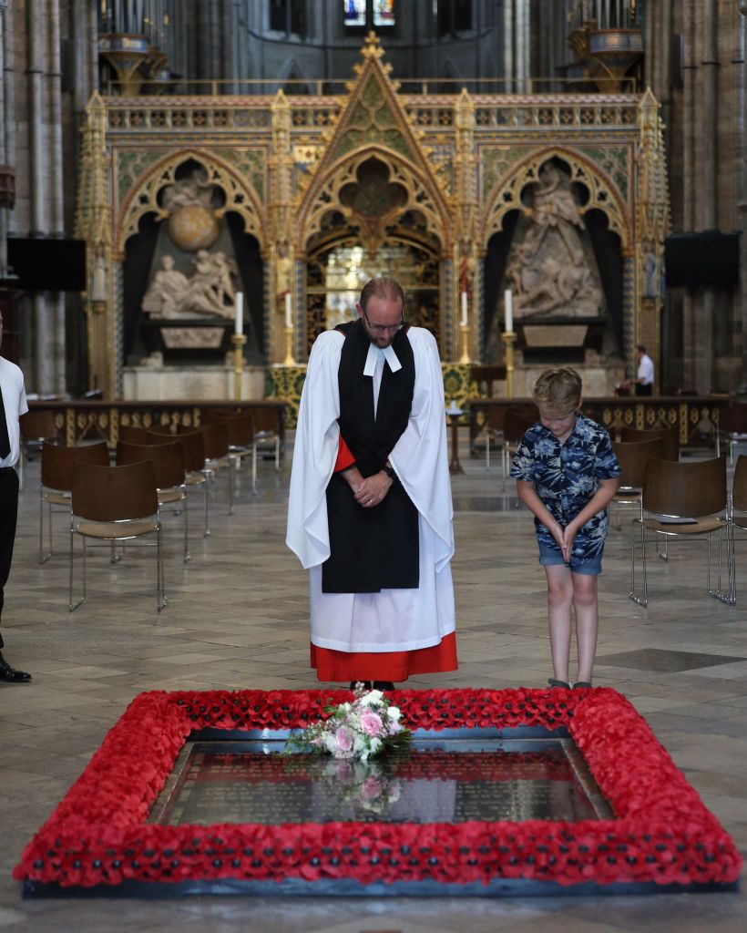 LONDON, UNITED KINGDOM - JULY 17: NEWS EDITORIAL USE ONLY. NO COMMERCIAL USE. NO MERCHANDISING, ADVERTISING, SOUVENIRS, MEMORABILIA or COLOURABLY SIMILAR. Reverend Anthony Ball, Canon of Westminster in Westminster Abbey in London with Toby Wright, son of the Reverend Paul Wright, Sub-Dean of the Chapel Royal, who brought Princess Beatrice's wedding bouquet straight from the wedding in Windsor which, like those of Royal brides, is traditionally placed on the Tomb of the Unknown Warrior on July 17, 2020 in London, England. (Photo by Yui Mok - WPA Pool/Getty Images)