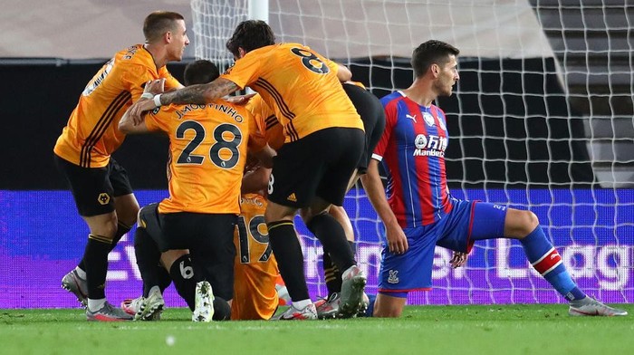 WOLVERHAMPTON, ENGLAND - JULY 20: Jonny Otto of Wolverhampton Wanderers (hidden) celebrates with teammates after scoring his teams second goal during the Premier League match between Wolverhampton Wanderers and Crystal Palace at Molineux on July 20, 2020 in Wolverhampton, England. Football Stadiums around Europe remain empty due to the Coronavirus Pandemic as Government social distancing laws prohibit fans inside venues resulting in all fixtures being played behind closed doors. (Photo by Catherine Ivill/Getty Images)