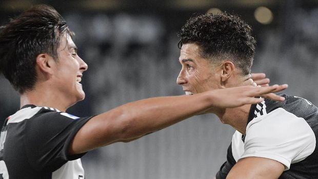 Juventus' Cristiano Ronaldo, right, celebrates with teammate Paulo Dybala after scoring a goal during the Italian Serie A soccer match between Juventus and Lazio at the Allianz stadium in Turin, Italy, Monday, July 20, 2020. (Marco Alpozzi/LaPresse via AP)