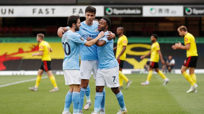 WATFORD, ENGLAND - JULY 21: Raheem Sterling of Manchester City celebrates with his team after he scores his teams first goal during the Premier League match between Watford FC and Manchester City at Vicarage Road on July 21, 2020 in Watford, England. Football Stadiums around Europe remain empty due to the Coronavirus Pandemic as Government social distancing laws prohibit fans inside venues resulting in all fixtures being played behind closed doors. (Photo by Adrian Dennis/Pool via Getty Images)
