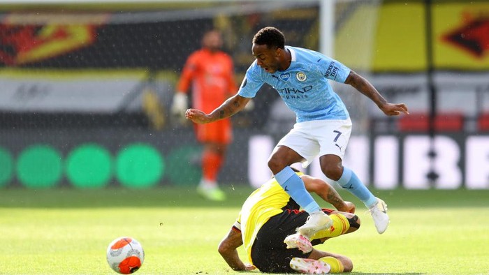 WATFORD, ENGLAND - JULY 21: Raheem Sterling of Manchester City is tackled by Troy Deeney of Watford  during the Premier League match between Watford FC and Manchester City at Vicarage Road on July 21, 2020 in Watford, England. Football Stadiums around Europe remain empty due to the Coronavirus Pandemic as Government social distancing laws prohibit fans inside venues resulting in all fixtures being played behind closed doors. (Photo by Richard Heathcote/Getty Images)