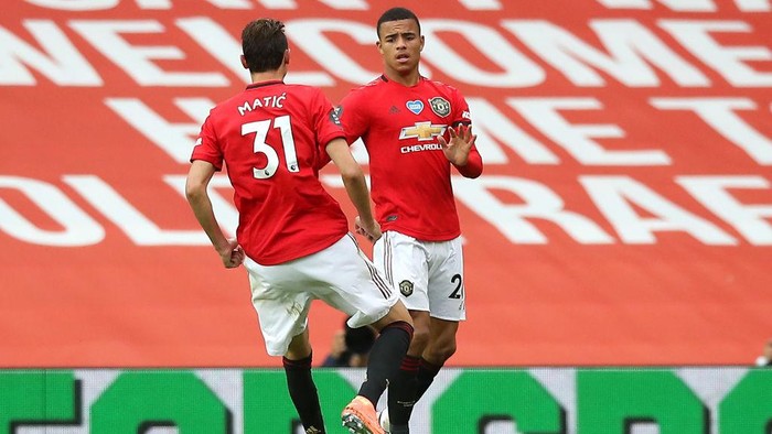 MANCHESTER, ENGLAND - JULY 22: Mason Greenwood of Manchester United celebrates with teammate Nemanja Matic after scoring his teams first goal during the Premier League match between Manchester United and West Ham United at Old Trafford on July 22, 2020 in Manchester, England. Football Stadiums around Europe remain empty due to the Coronavirus Pandemic as Government social distancing laws prohibit fans inside venues resulting in all fixtures being played behind closed doors. (Photo by Martin Rickett/Pool via Getty Images)